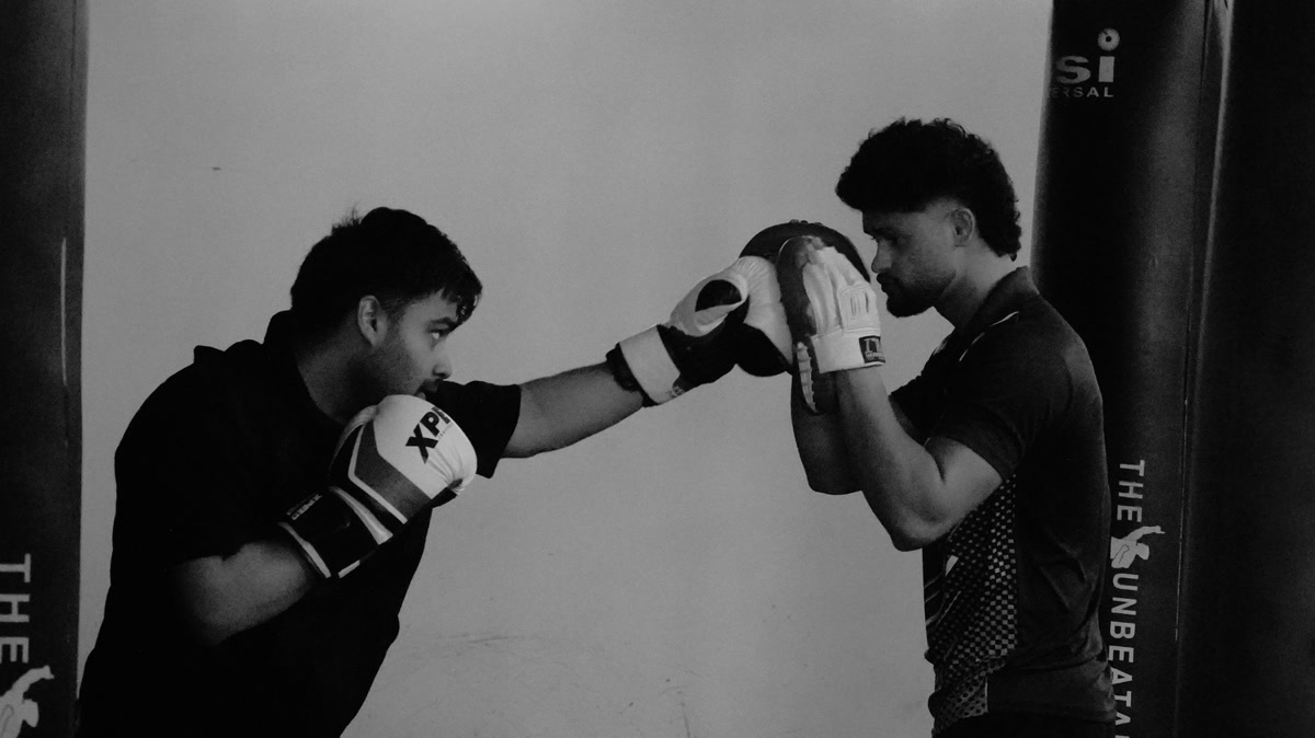 Beginner preparing for a home boxing session with three training days marked on a weekly calendar
