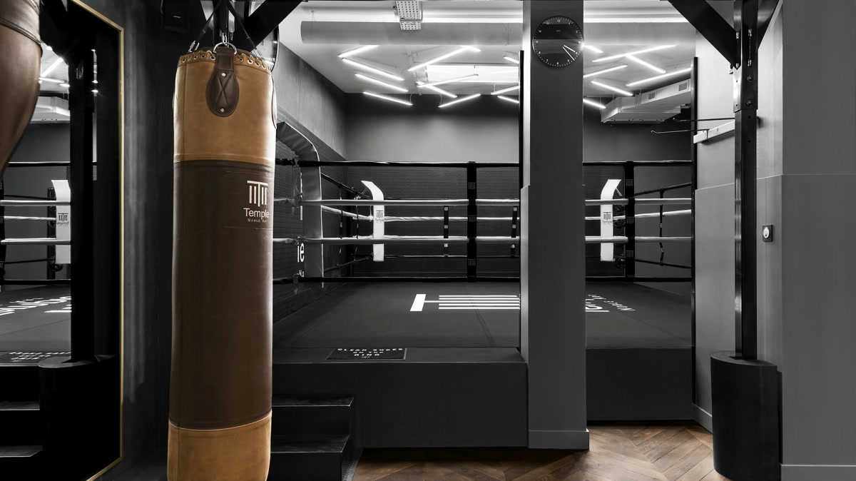 Beginner completing a controlled heavy-bag round with clear space around the bag
