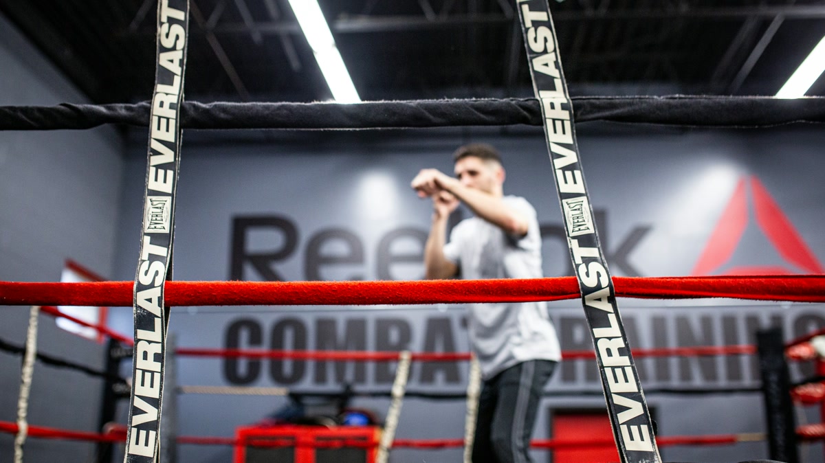 Boxer throwing a balanced rear-hand cross with the lead hand in guard