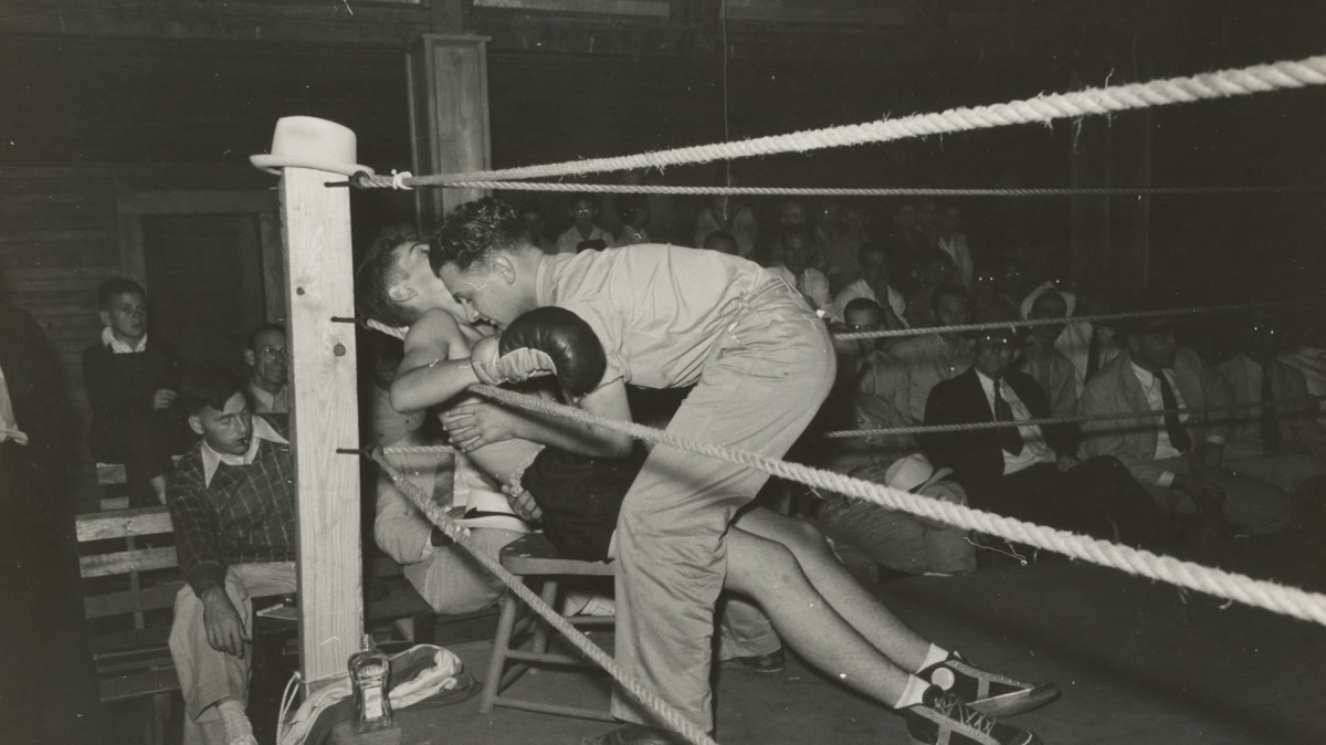 Beginner transitioning from light movement into a boxing stance during a warm-up
