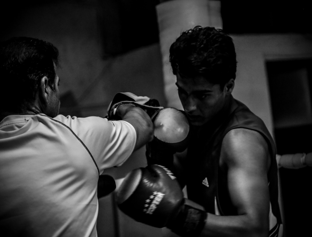Boxer in a composed guard stepping away at an angle after an exchange