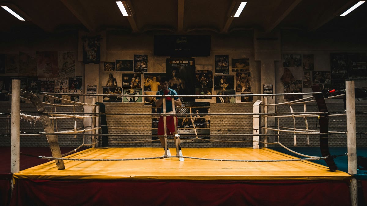 Beginner shadowboxing toward an imagined opponent in a clear training space