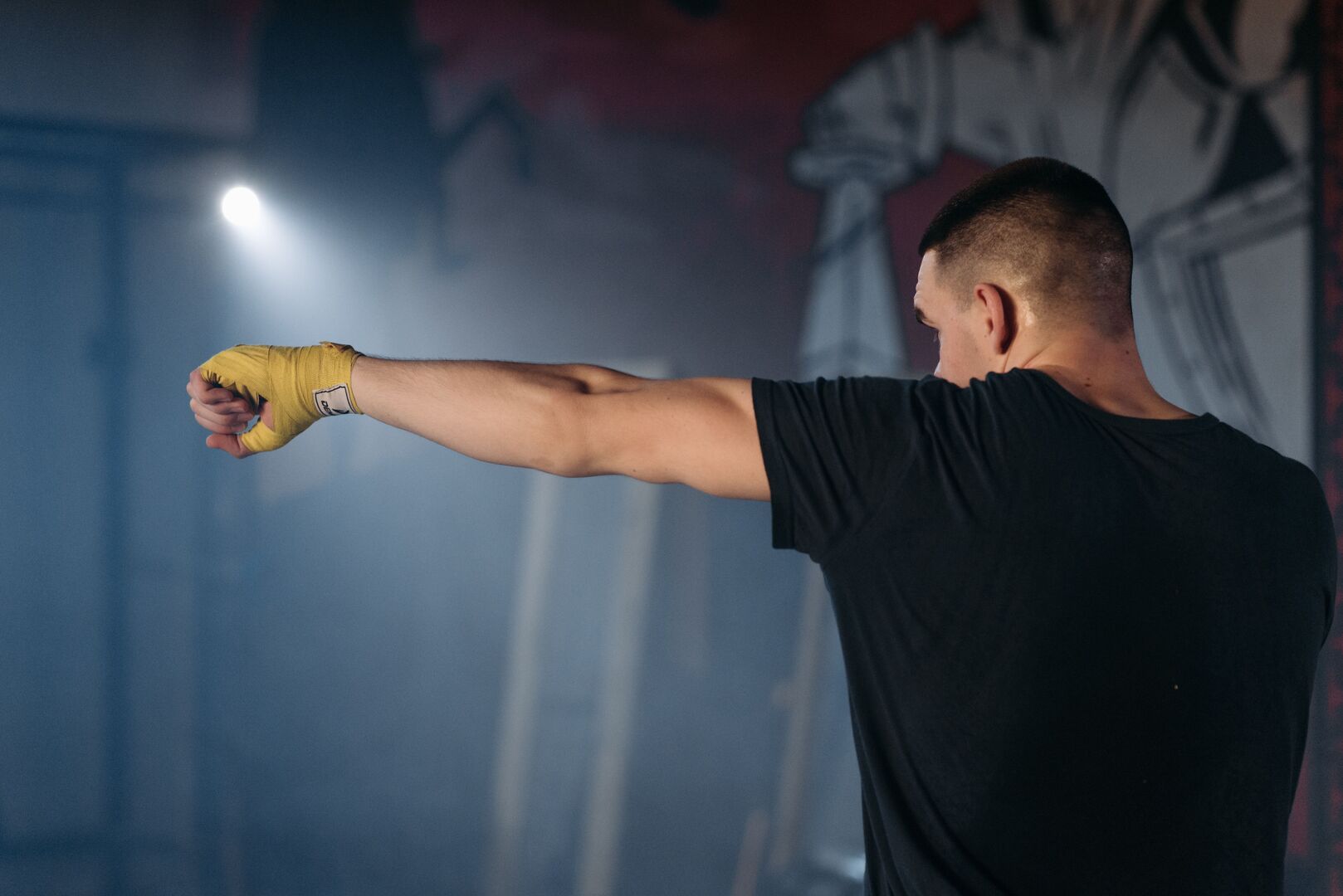 Boxer extending a jab while keeping the rear hand at the cheek and chin protected