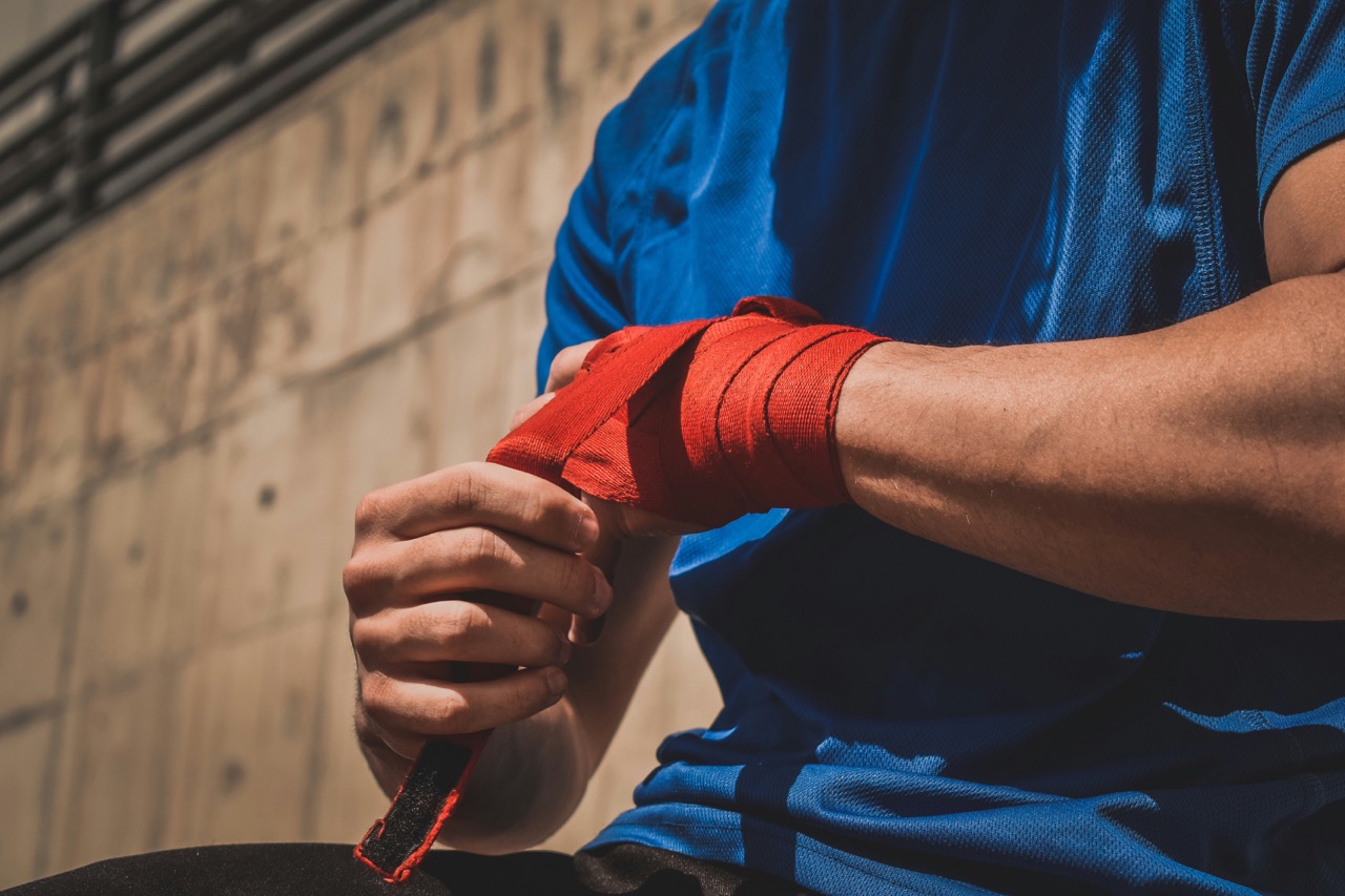 Boxer calmly wrapping hands before returning to training after a break